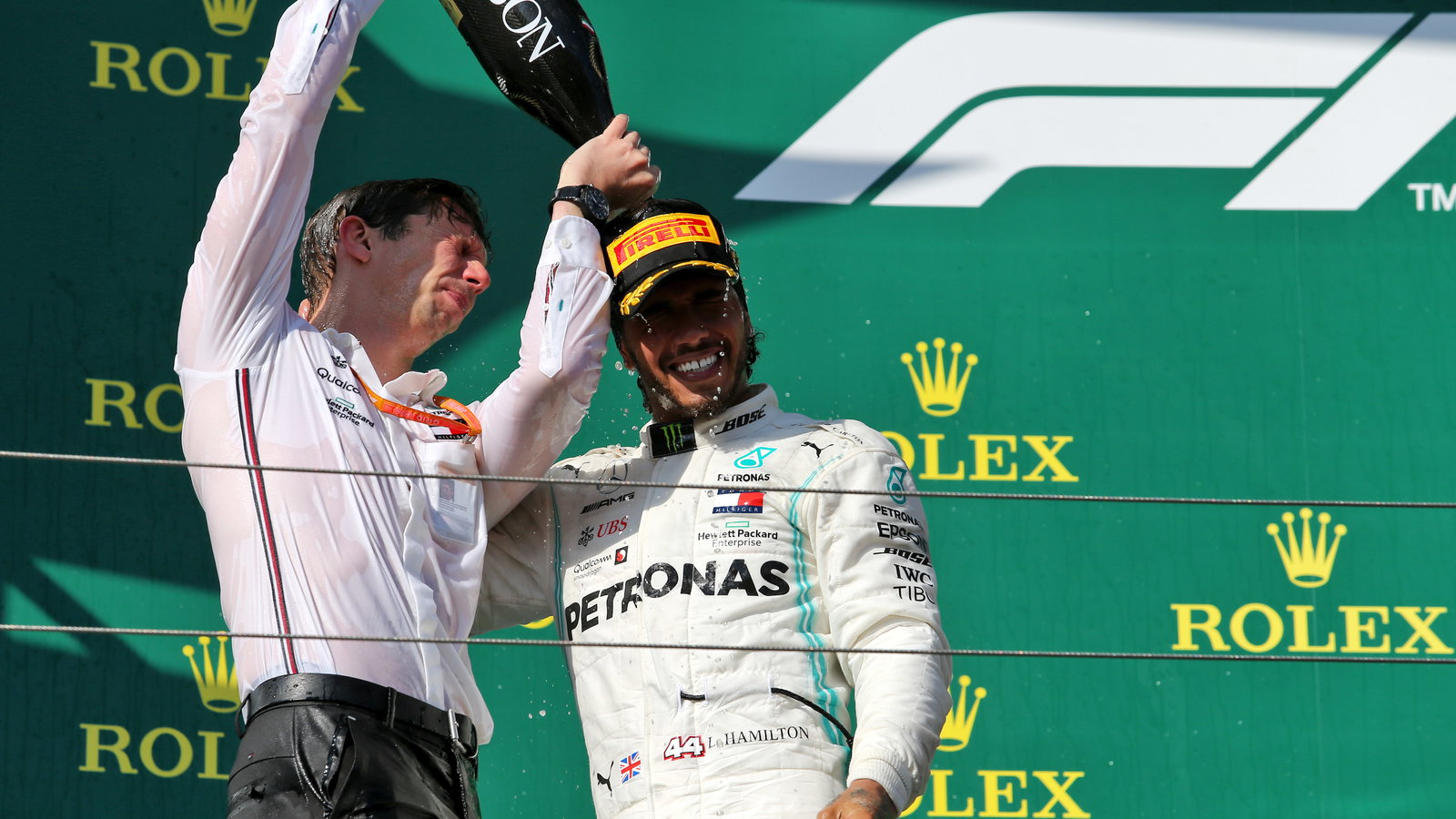 James Vowles and Lewis Hamilton celebrate on the podium. 
