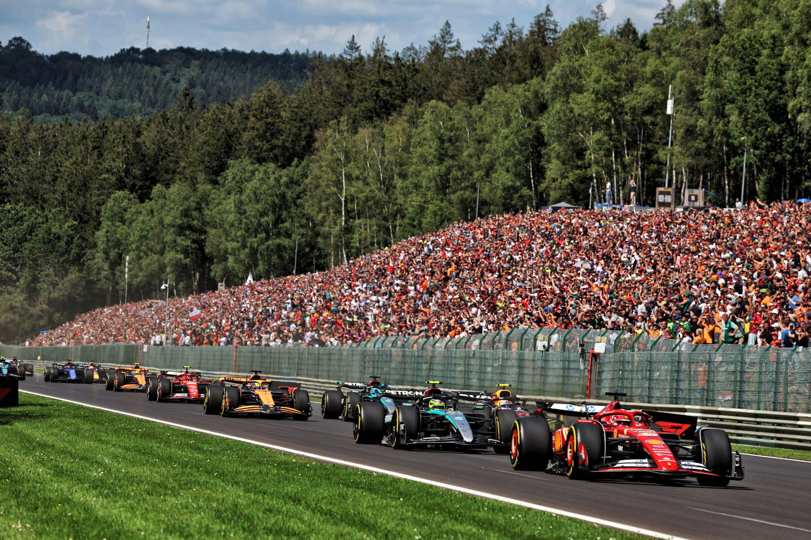 Charles Leclerc leads at the start of the Belgian Grand Prix 