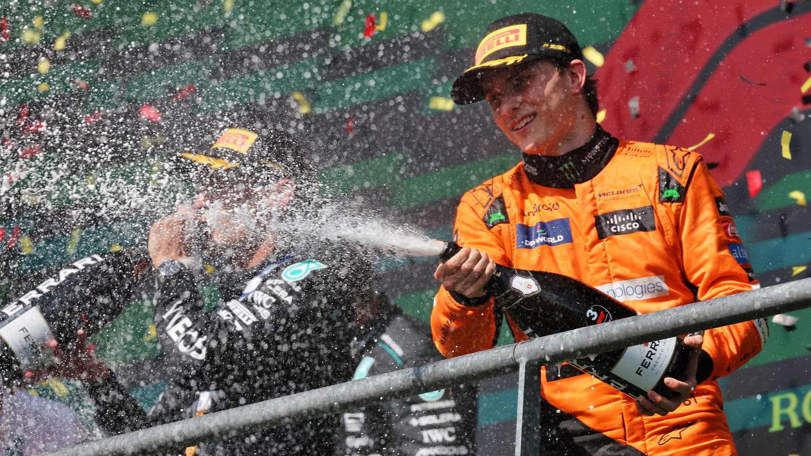 Oscar Piastri celebrates on the podium at the Belgian GP