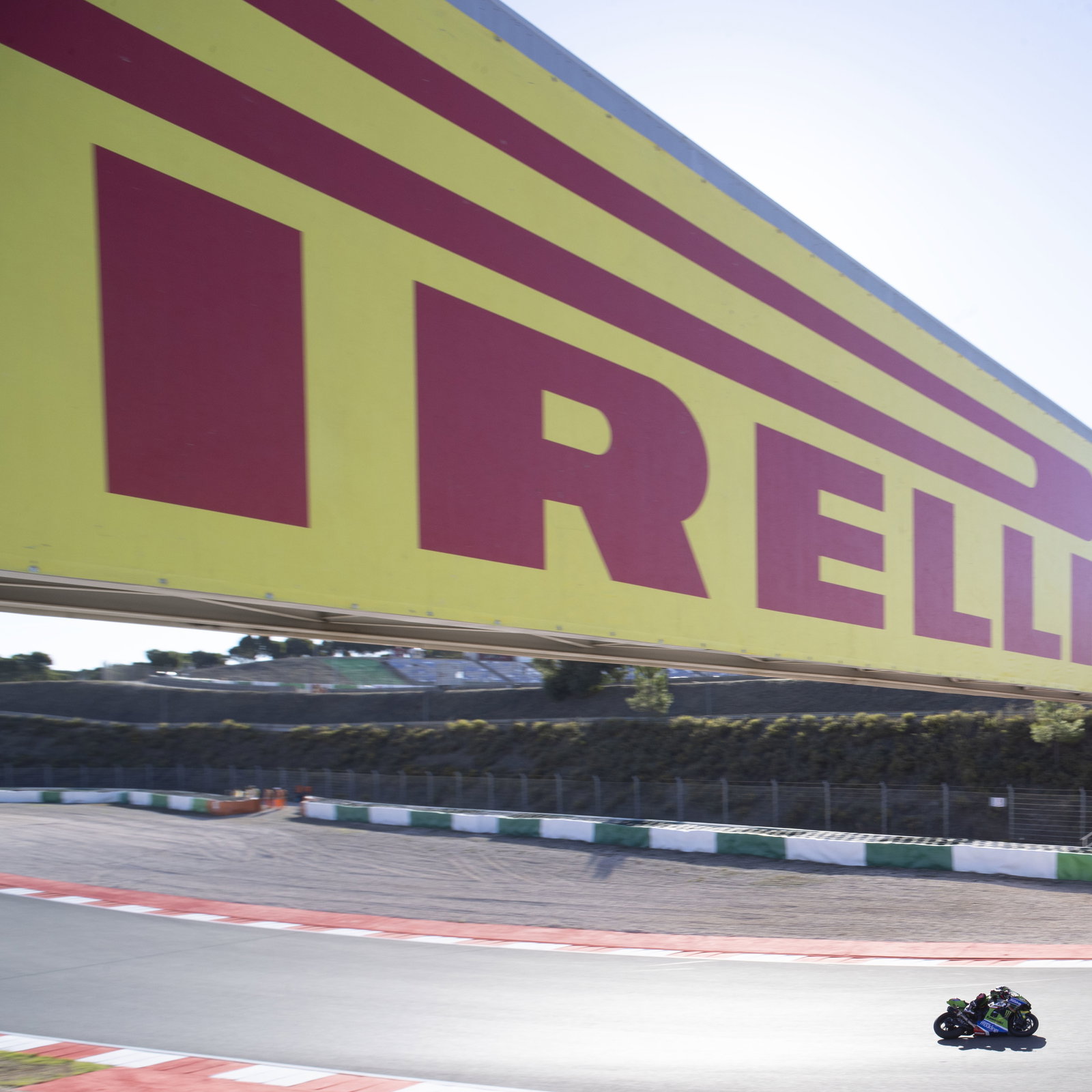 Alex Lowes passes under a Pirelli-badged gantry, 2024 Portuguese WorldSBK. Credit: Gold and Goose.
