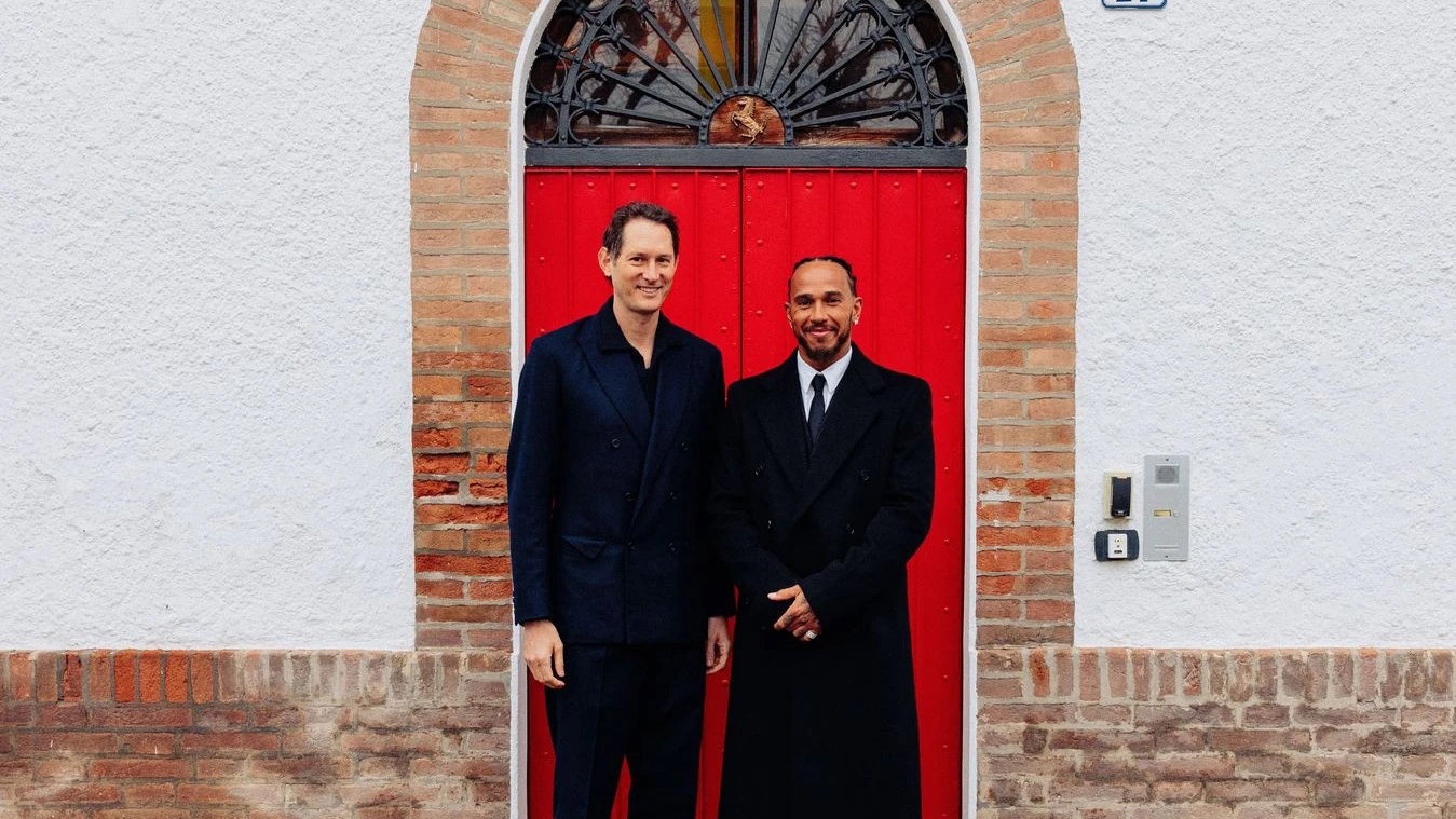 John Elkann alongside Lewis Hamilton