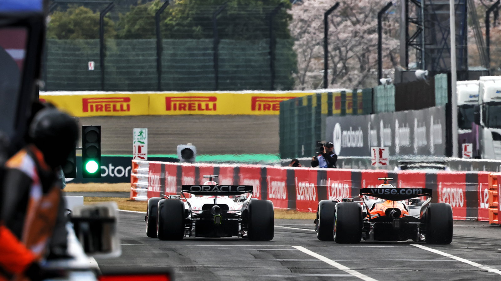 Max Verstappen and Lando Norris leave the pit lane