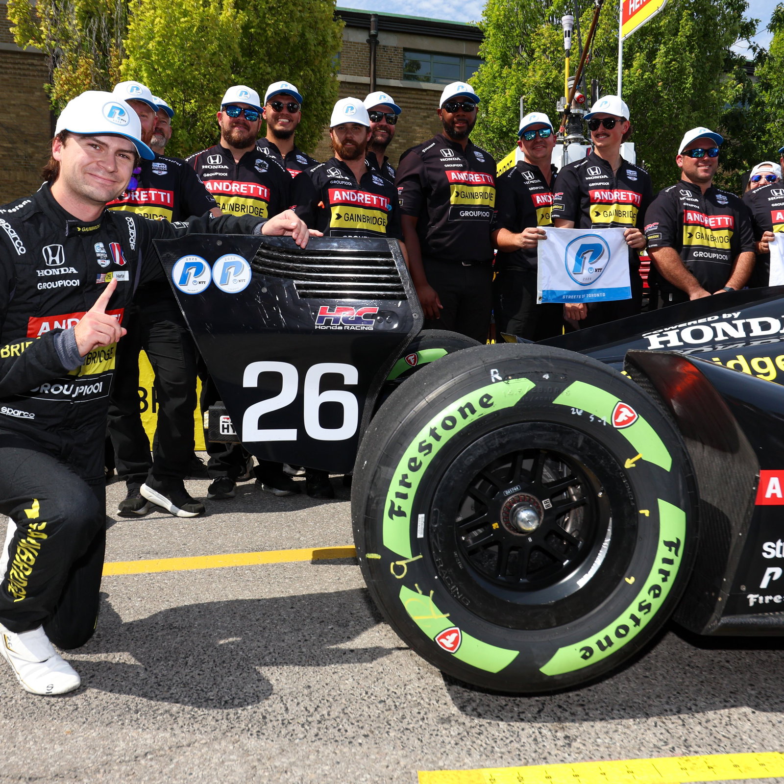 Colton Herta next to his car after pole at Toronto.