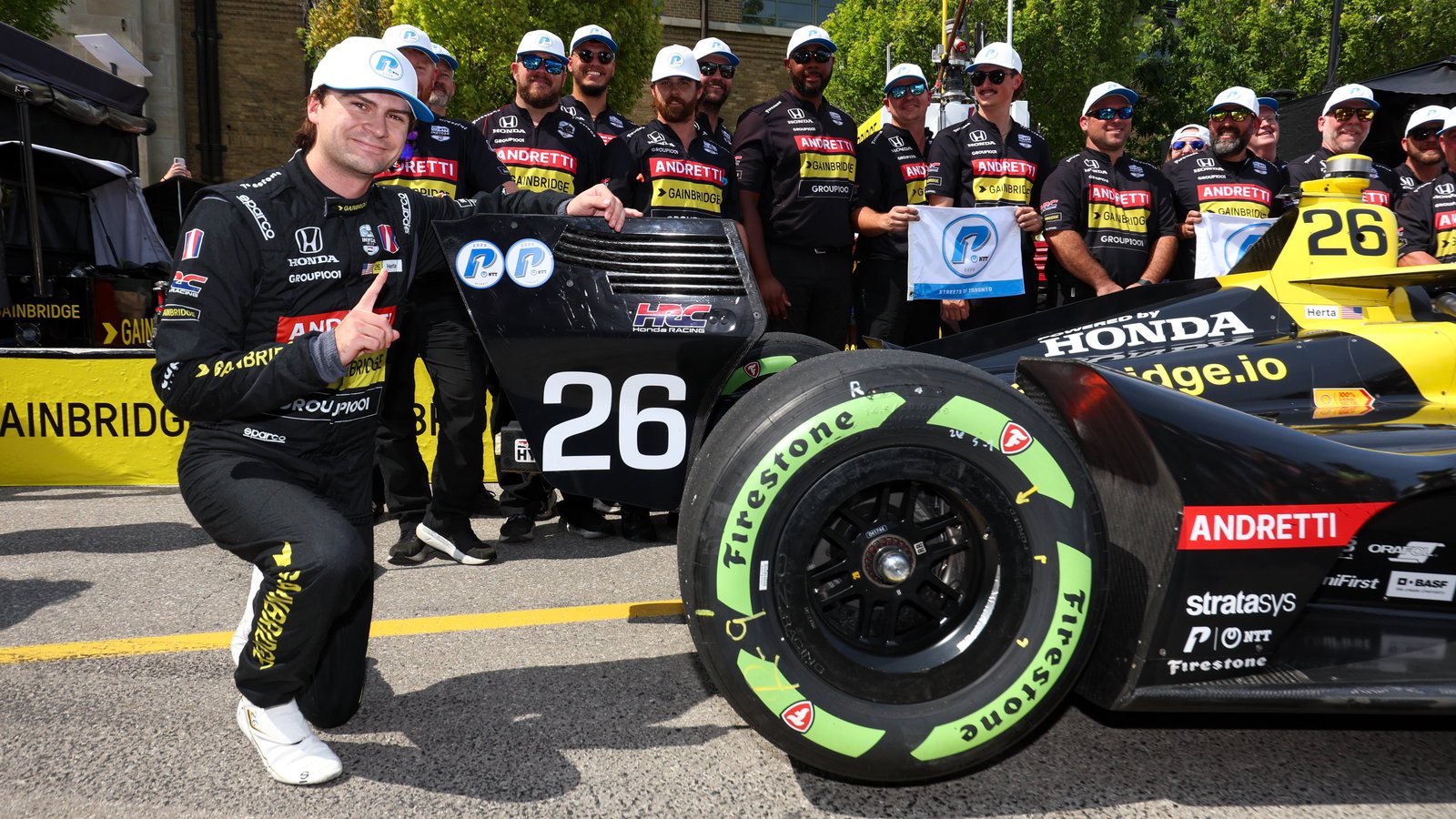 Colton Herta next to his car after pole at Toronto.