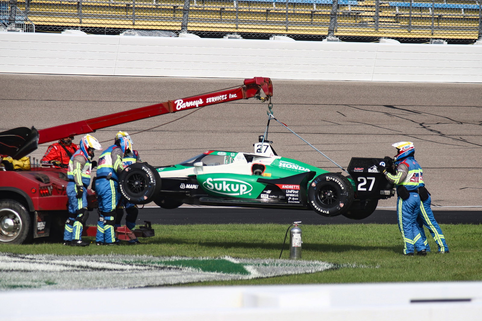 Kyle Kirkwood's car being picked up after a crash.