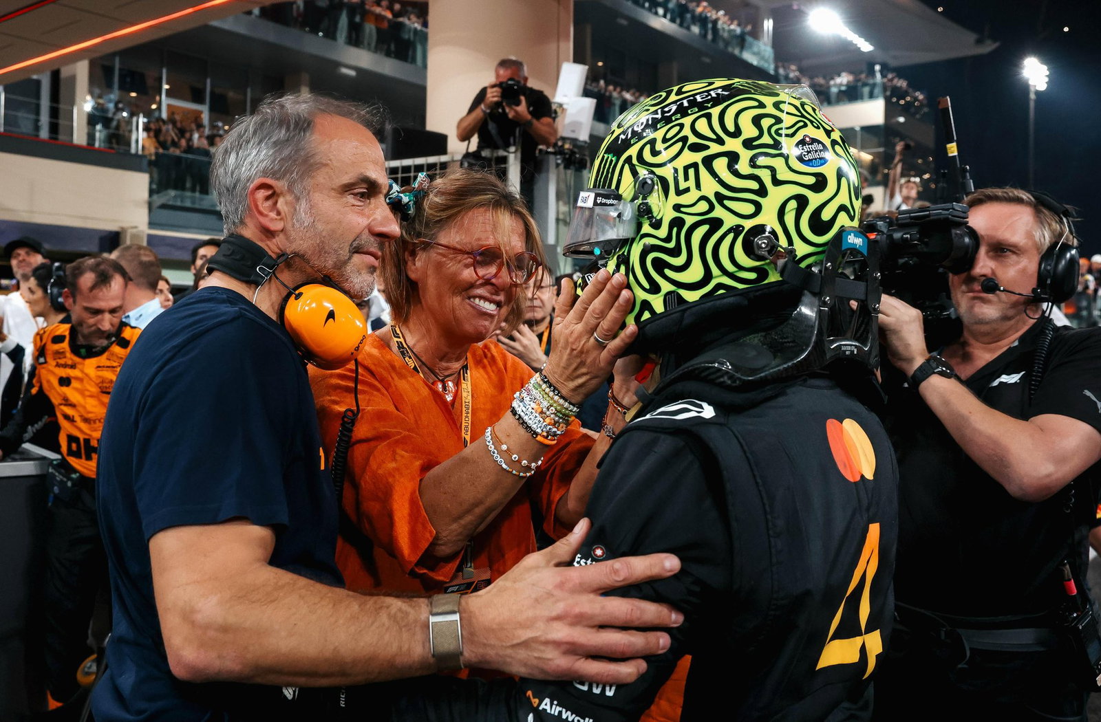 Norris celebrates with his parents