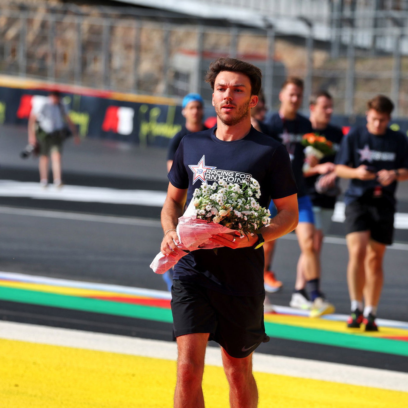 Gasly lays flowers in the now annual 'Run for Anthoine' 