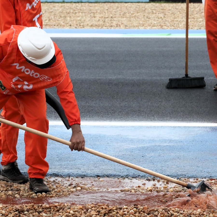  Marshals cleaning track during delayed Moto3 practice, Brazilian MotoGP, 20 March 2026