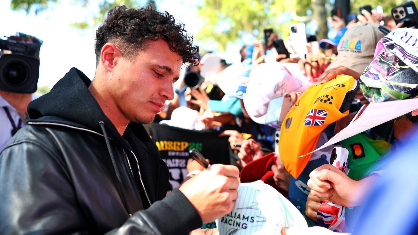 Lando Norris signs autographs for fans at Albert Park