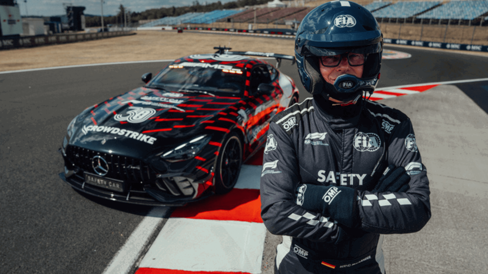 Safety car driver Bernd Maylander poses with the new-look Mercedes