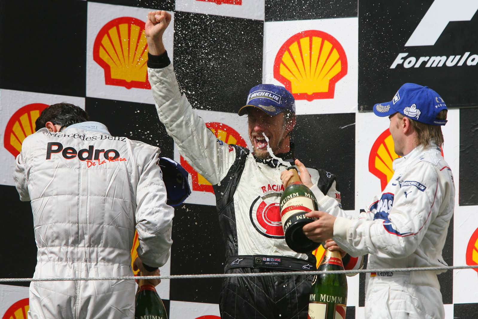 Button celebrates on the top step of the podium for the first time