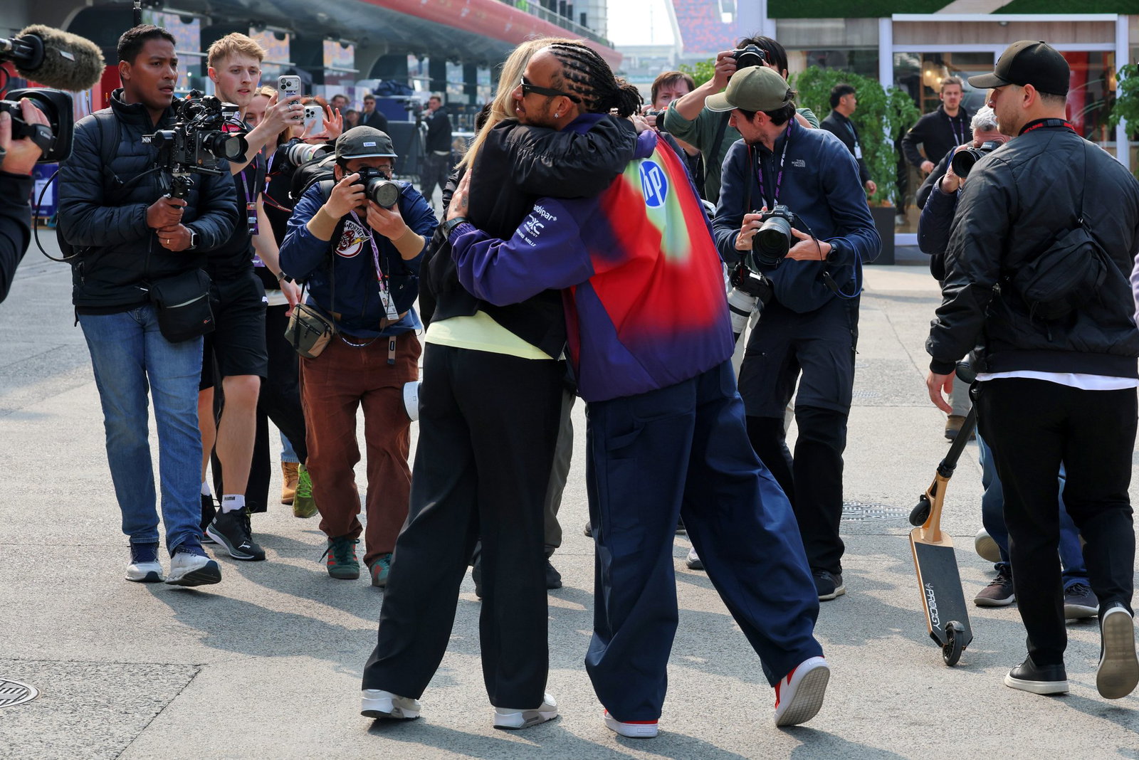 Brookes and Hamilton share a hug in the Shanghai paddock