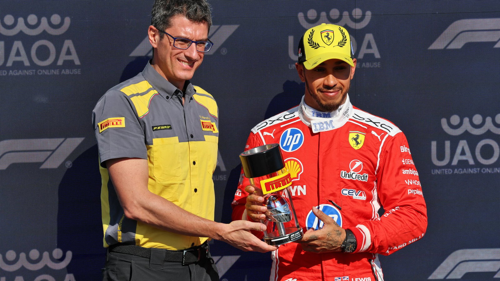 Hamilton is presented with the sprint pole trophy 