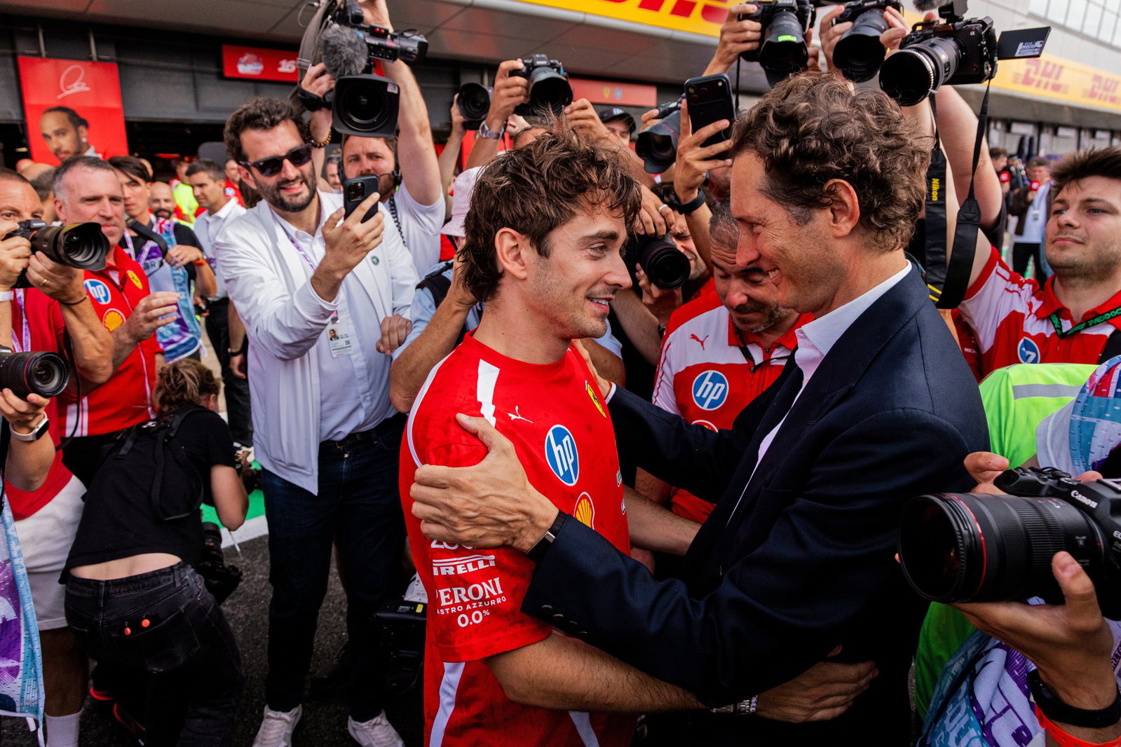 Leclerc is congratulated by Ferrari president John Elkann