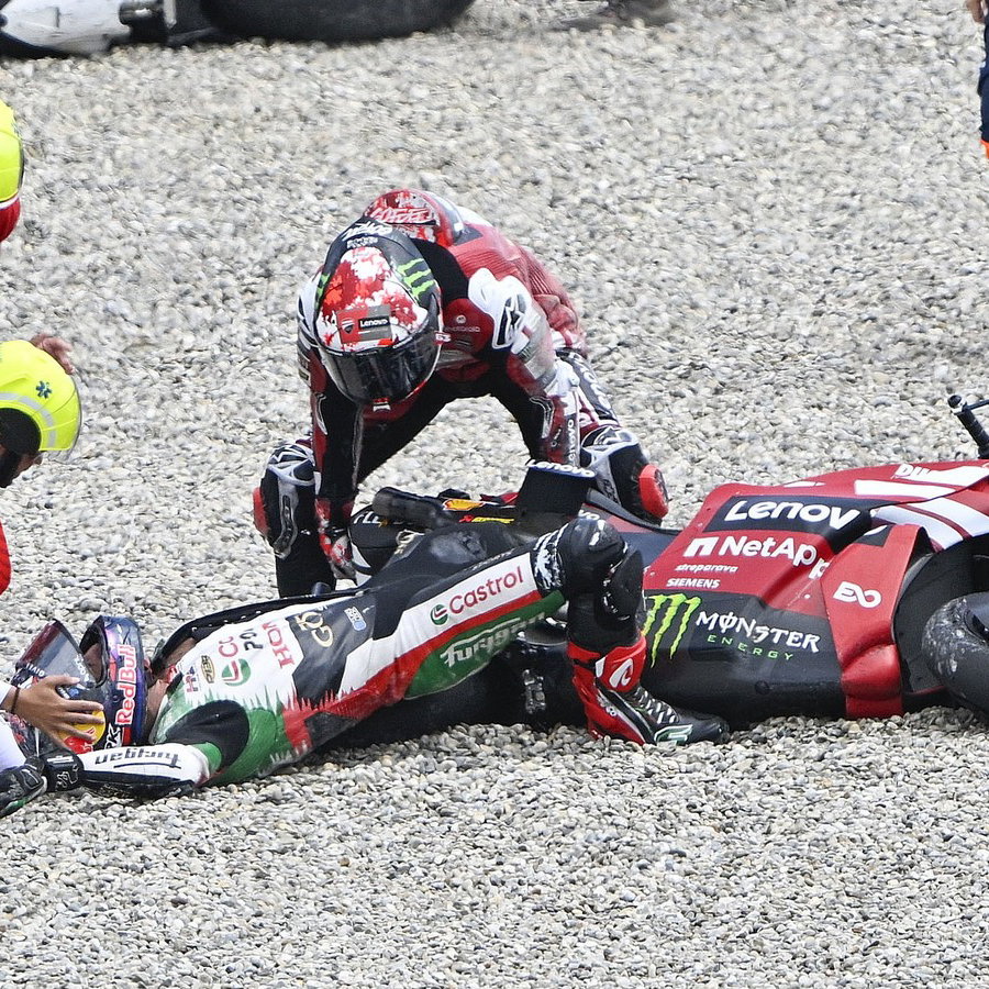 Pecco Bagnaia helps Johann Zarco after the Catalunya restart accident.