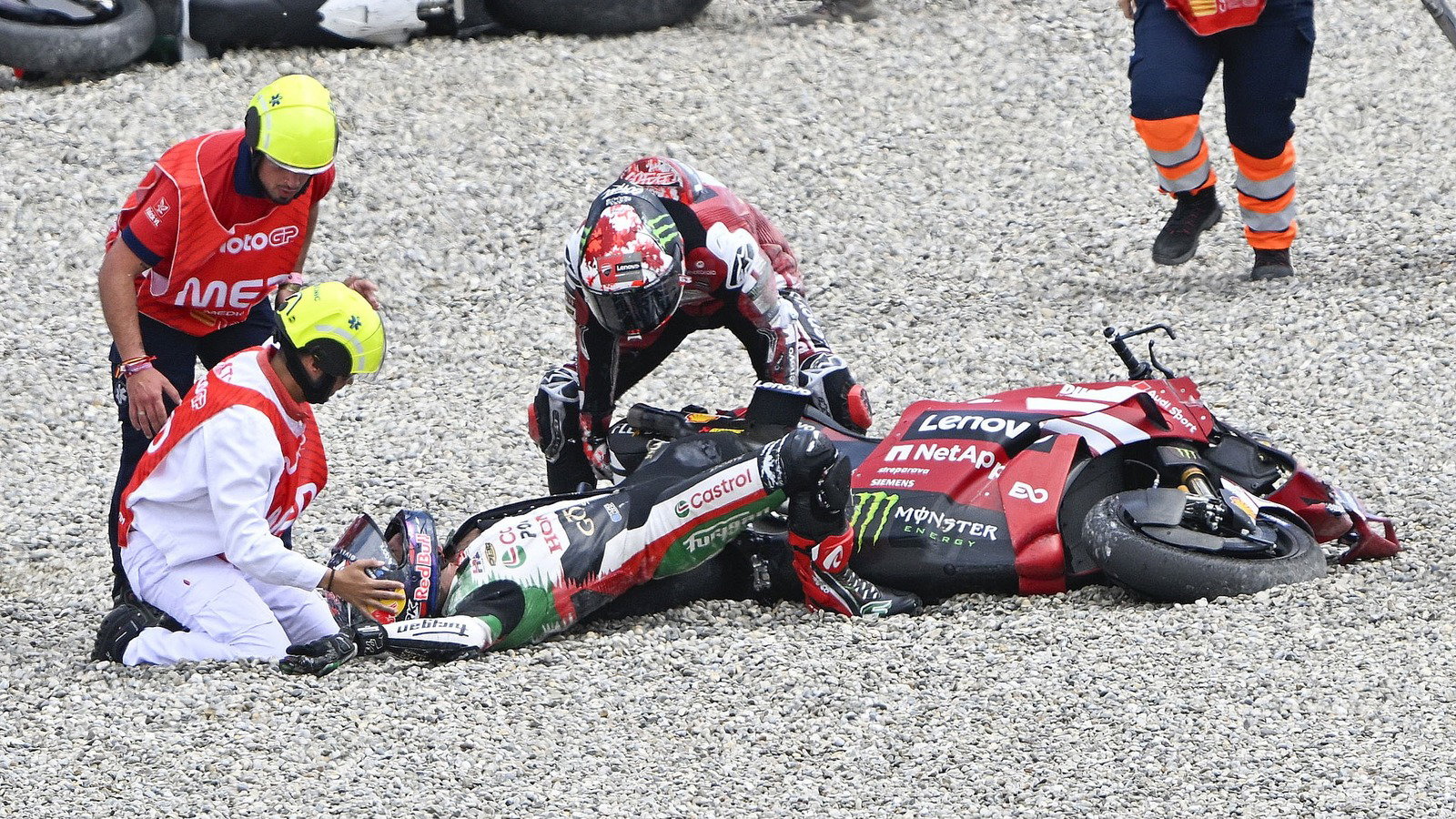 Pecco Bagnaia helps Johann Zarco after the Catalunya restart accident.