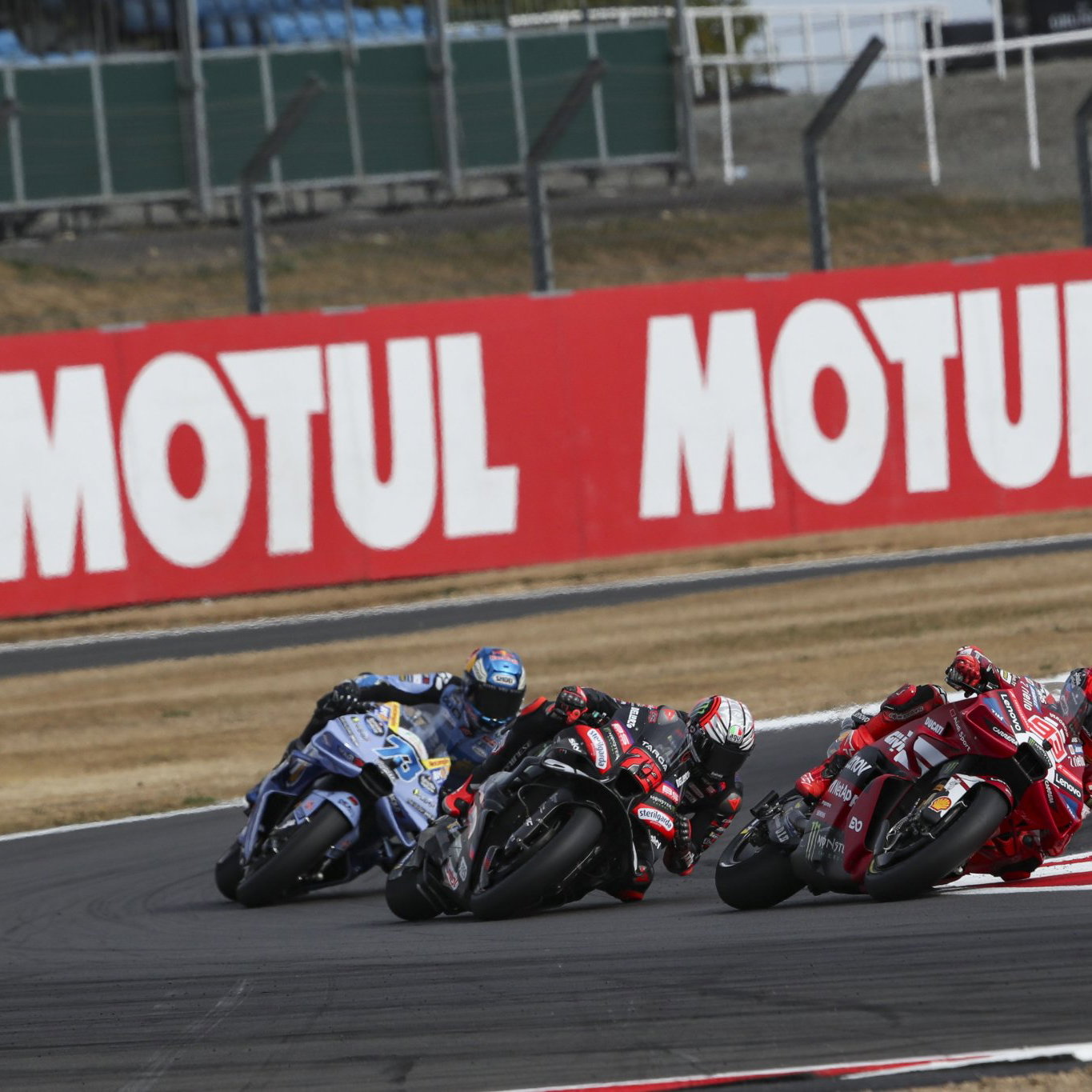 Marc Marquez leads Marco Bezzecchi, Alex Marquez, 2026 MotoGP British Grand Prix. Credit: Gold and Goose.