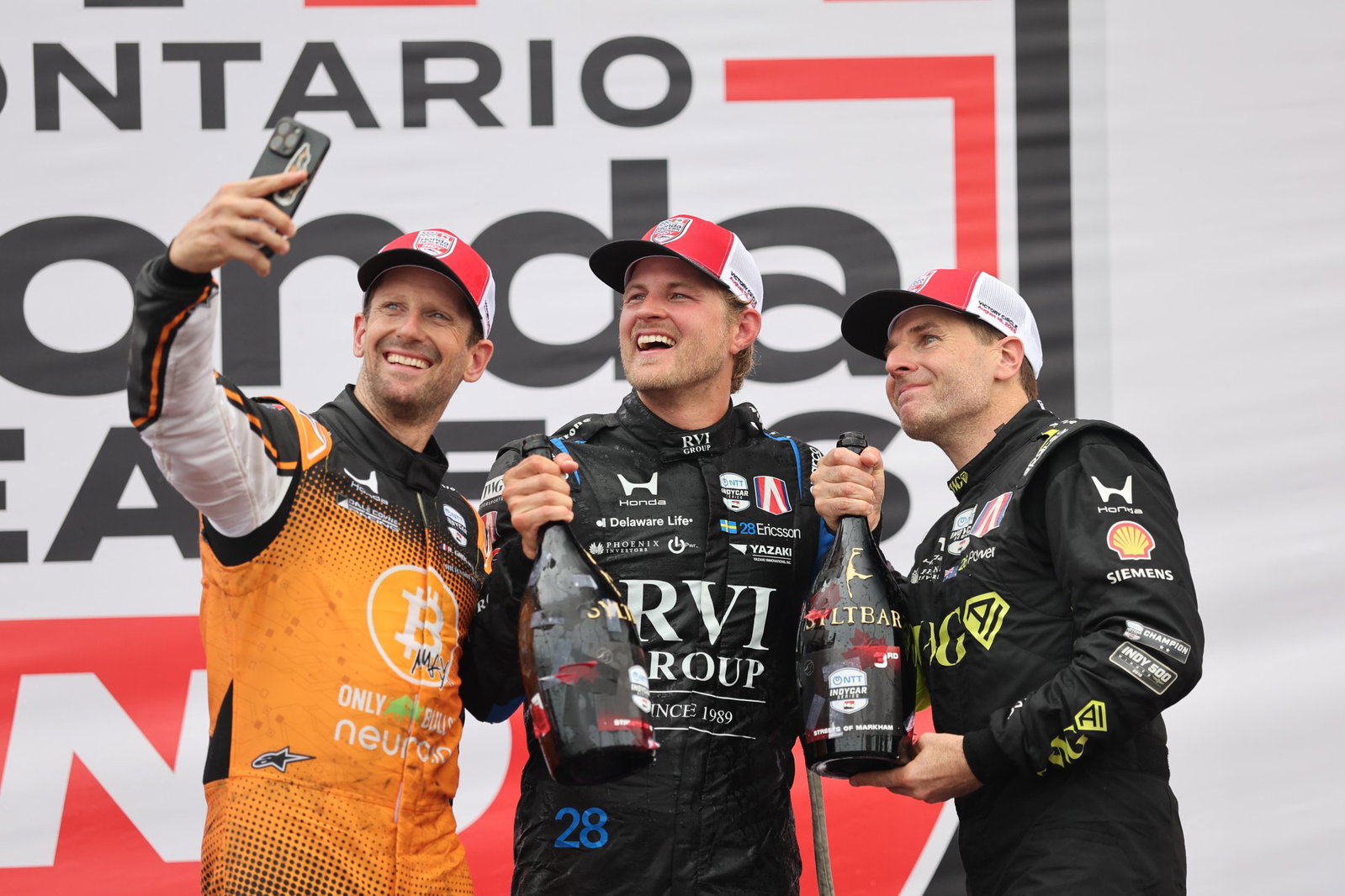 Grosjean, Ericsson and Power celebrate on the podium