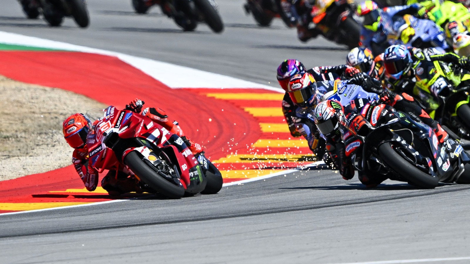 Sparks as Marc Marquez's ride height device remains down at Turn 2, 2026 Aragon MotoGP.