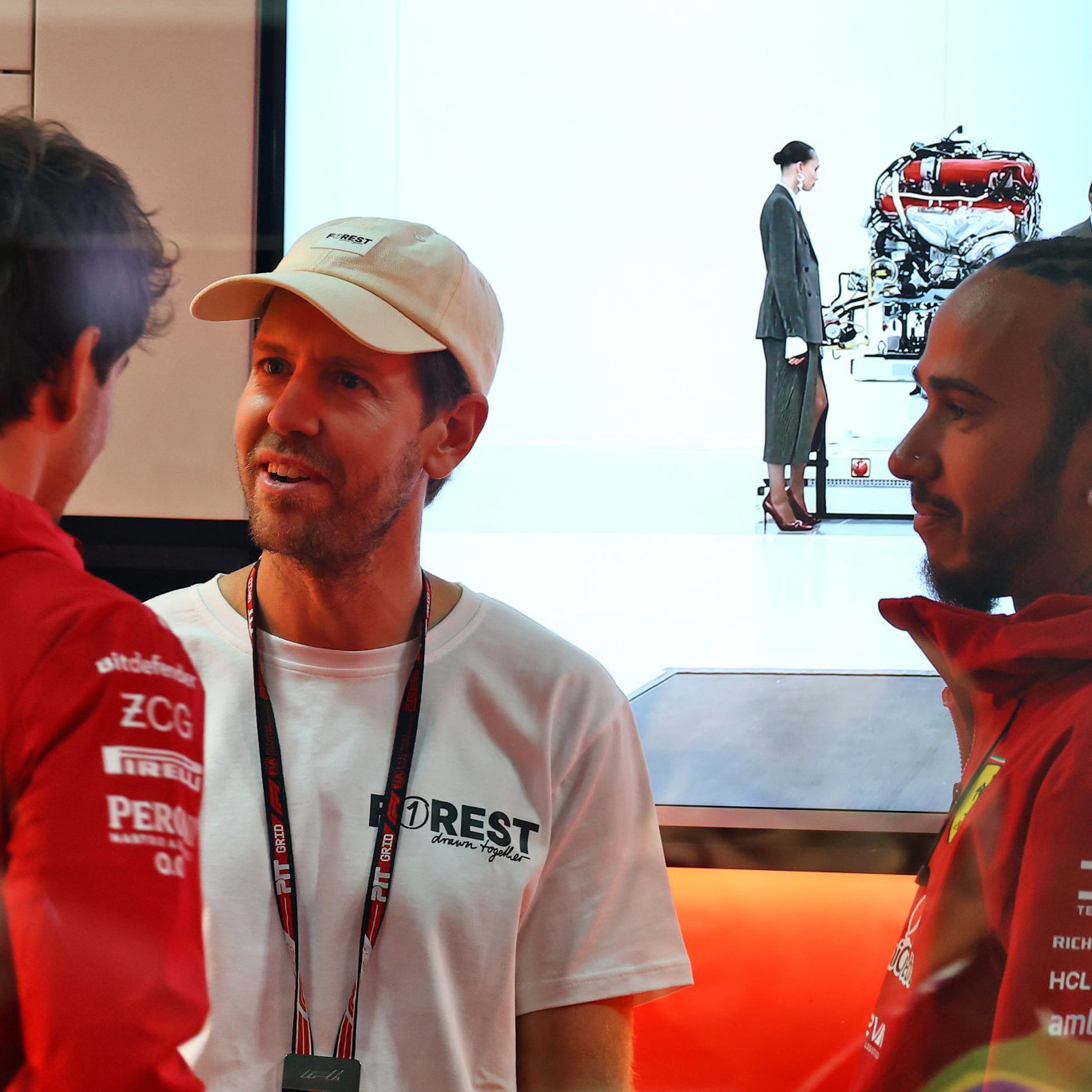 Vettel in conversation with Ferrari drivers Hamilton and Leclerc