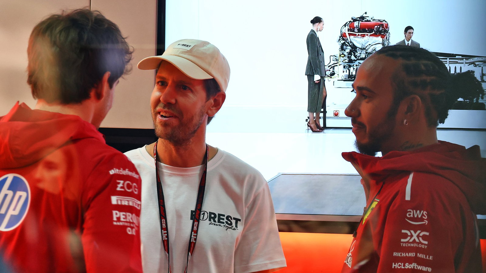 Vettel in conversation with Ferrari drivers Hamilton and Leclerc