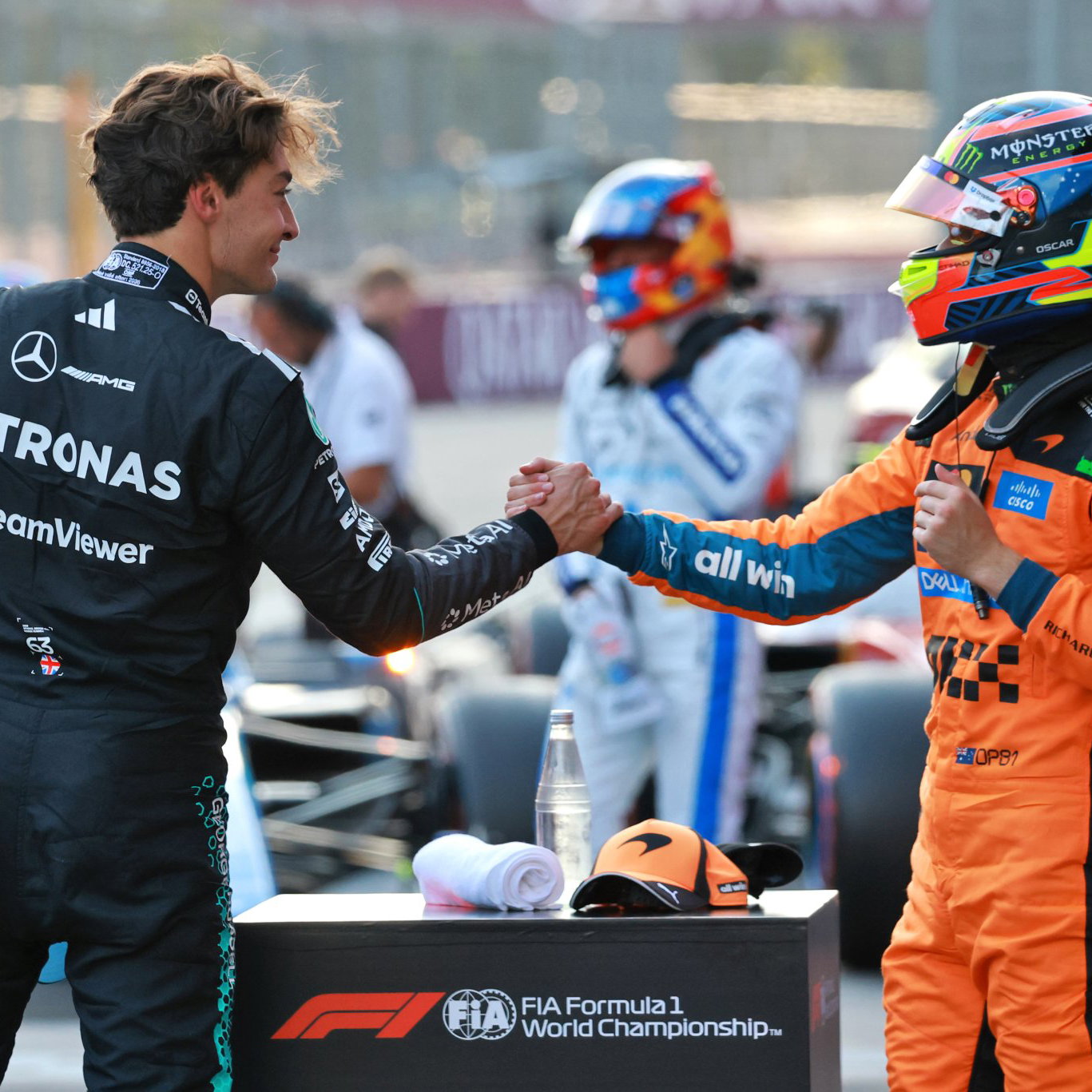 Polesitter George Russell is congratulated by third-placed Oscar Piastri