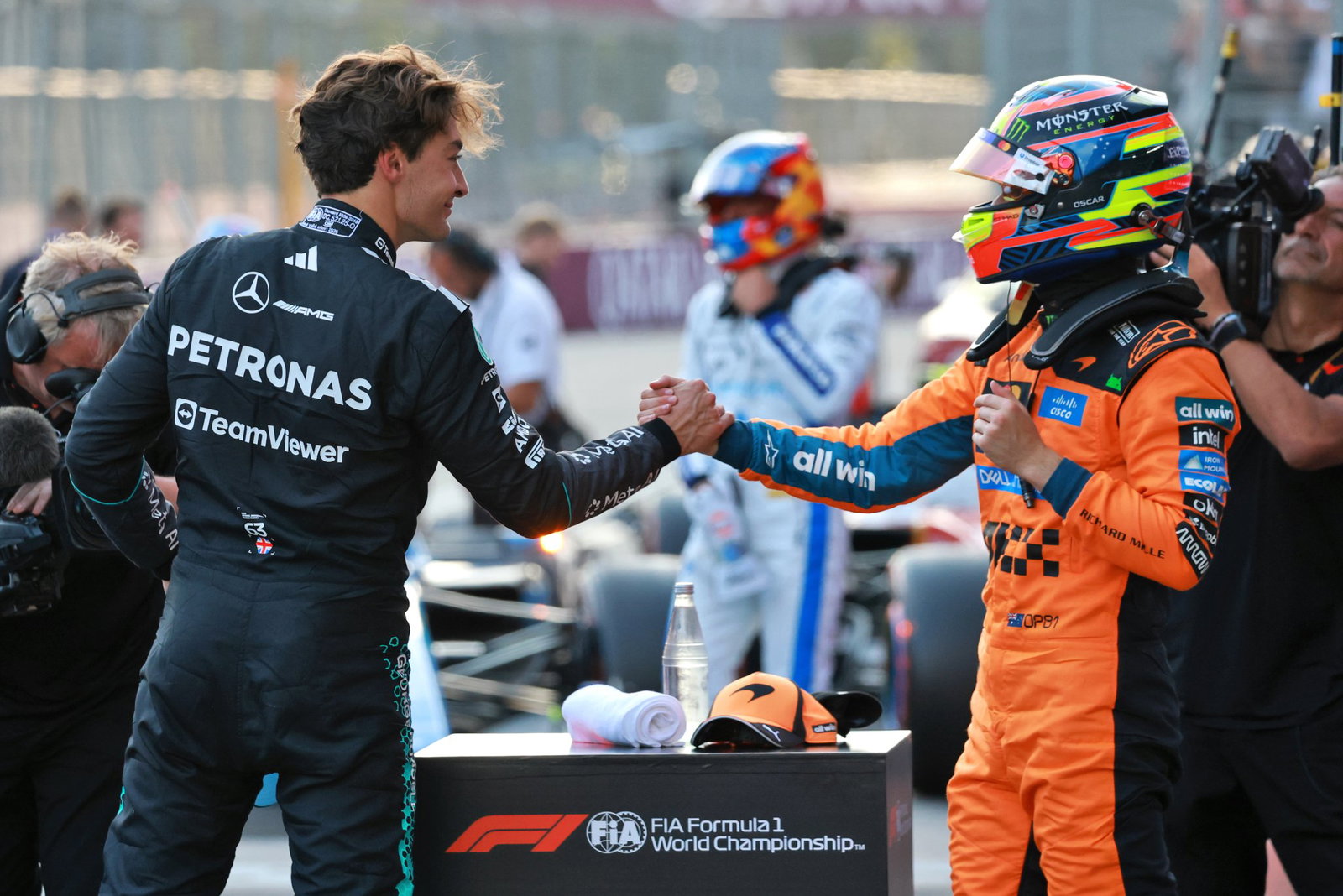Polesitter George Russell is congratulated by third-placed Oscar Piastri