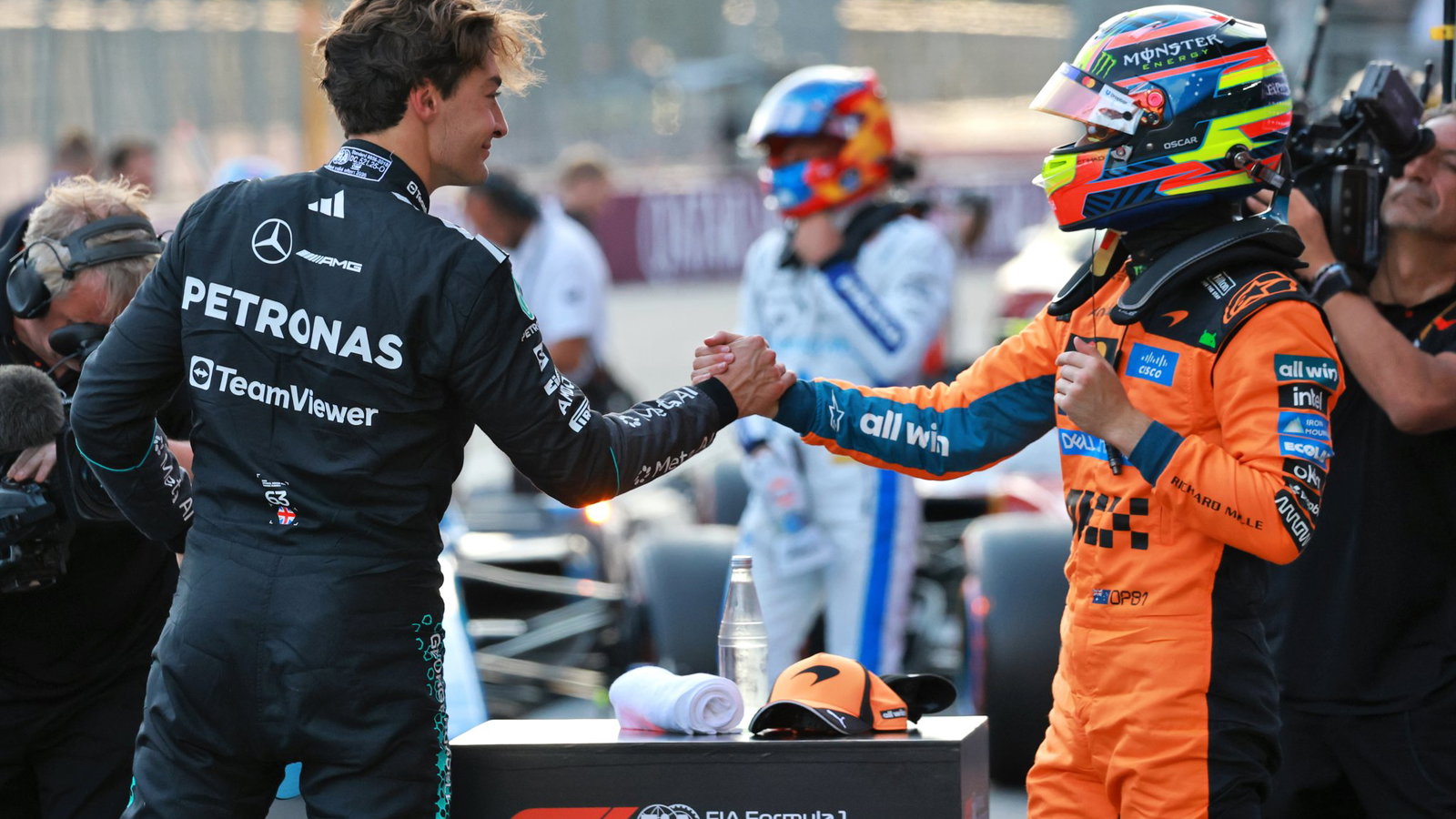 Polesitter George Russell is congratulated by third-placed Oscar Piastri
