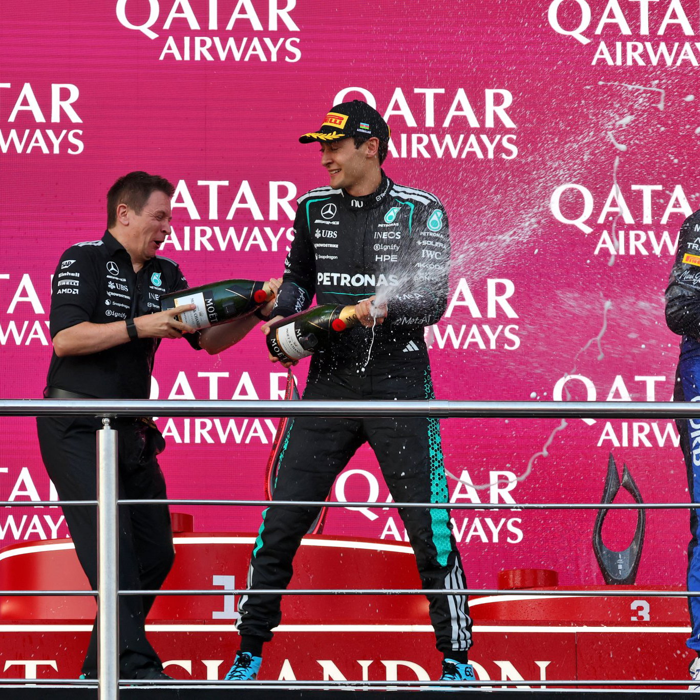 Russell and Verstappen celebrate on the Baku podium 