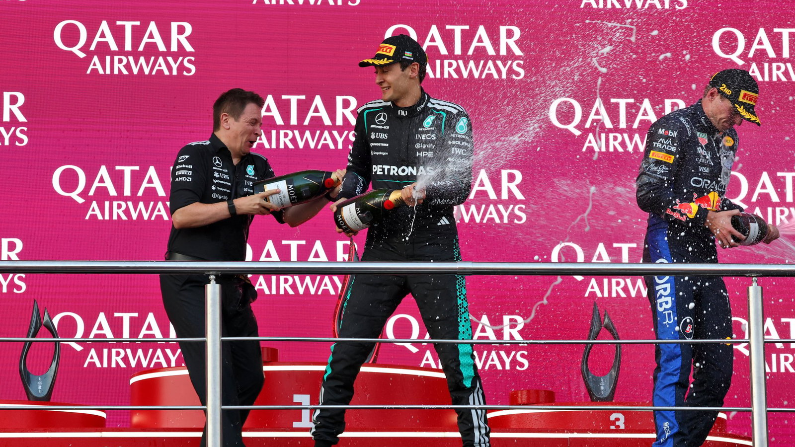 Russell and Verstappen celebrate on the Baku podium