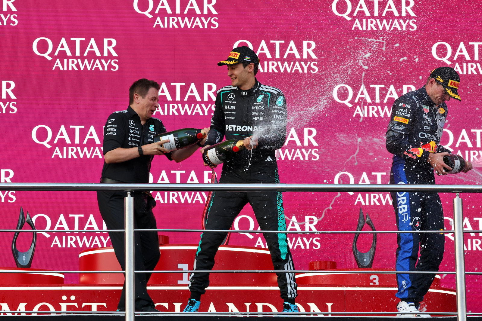 Russell and Verstappen celebrate on the Baku podium