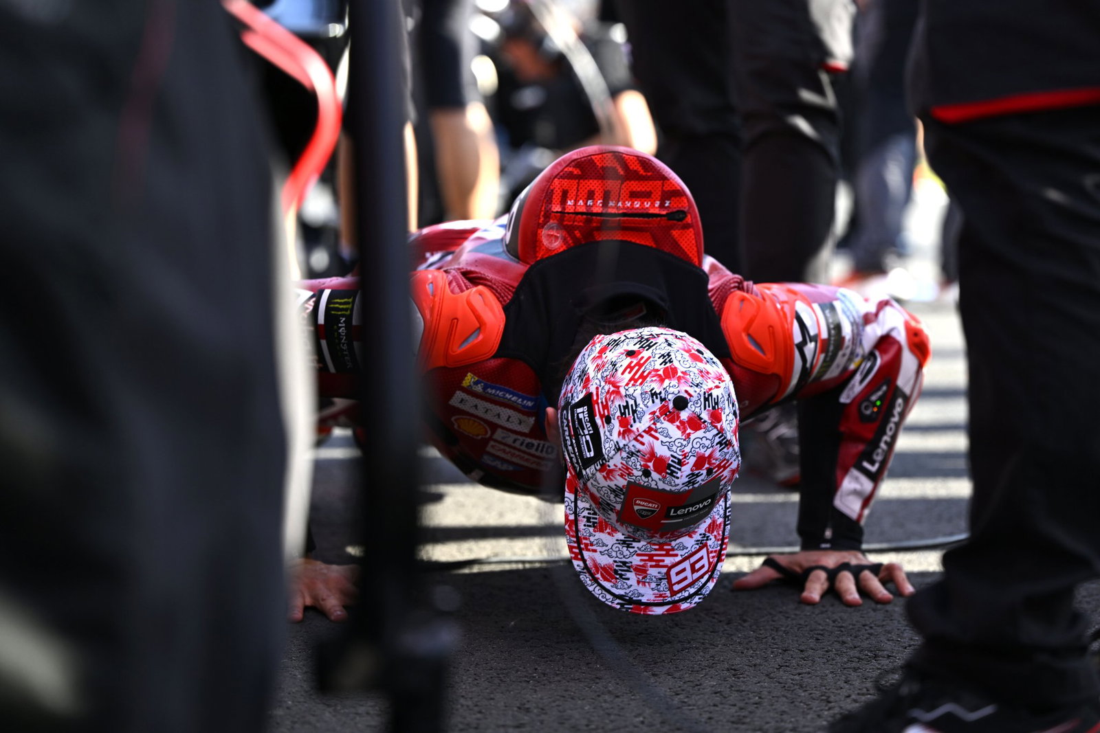 Marc Marquez does push-ups on the grid before 2026 Japanese MotoGP Sprint. Credit: Gold and Goose.