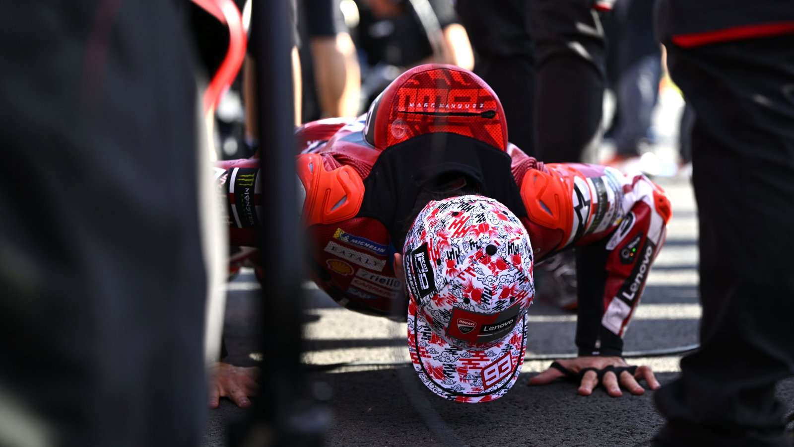Marc Marquez does push-ups on the grid before 2026 Japanese MotoGP Sprint. Credit: Gold and Goose.
