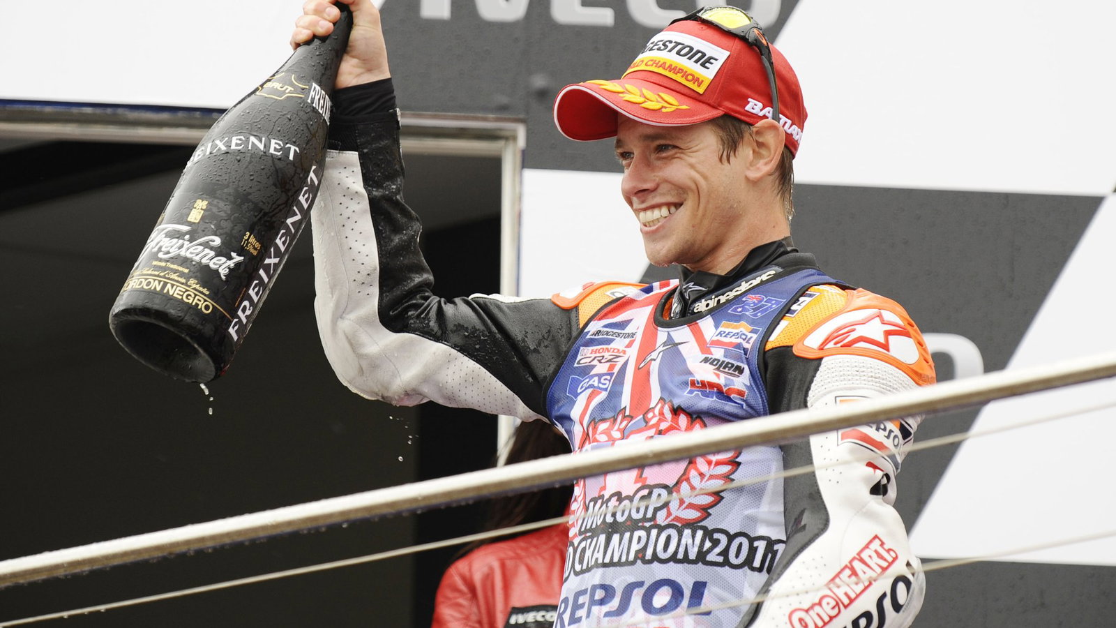 Casey Stoner stands on the Australian MotoGP podium after winning the 2011 title.