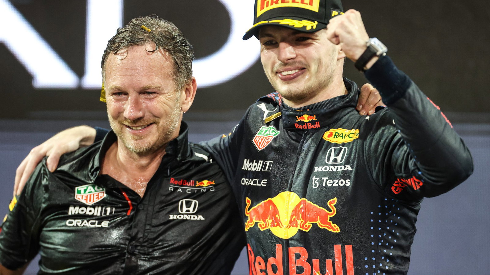 Christian Horner and Max Verstappen celebrate on the Abu Dhabi podium
