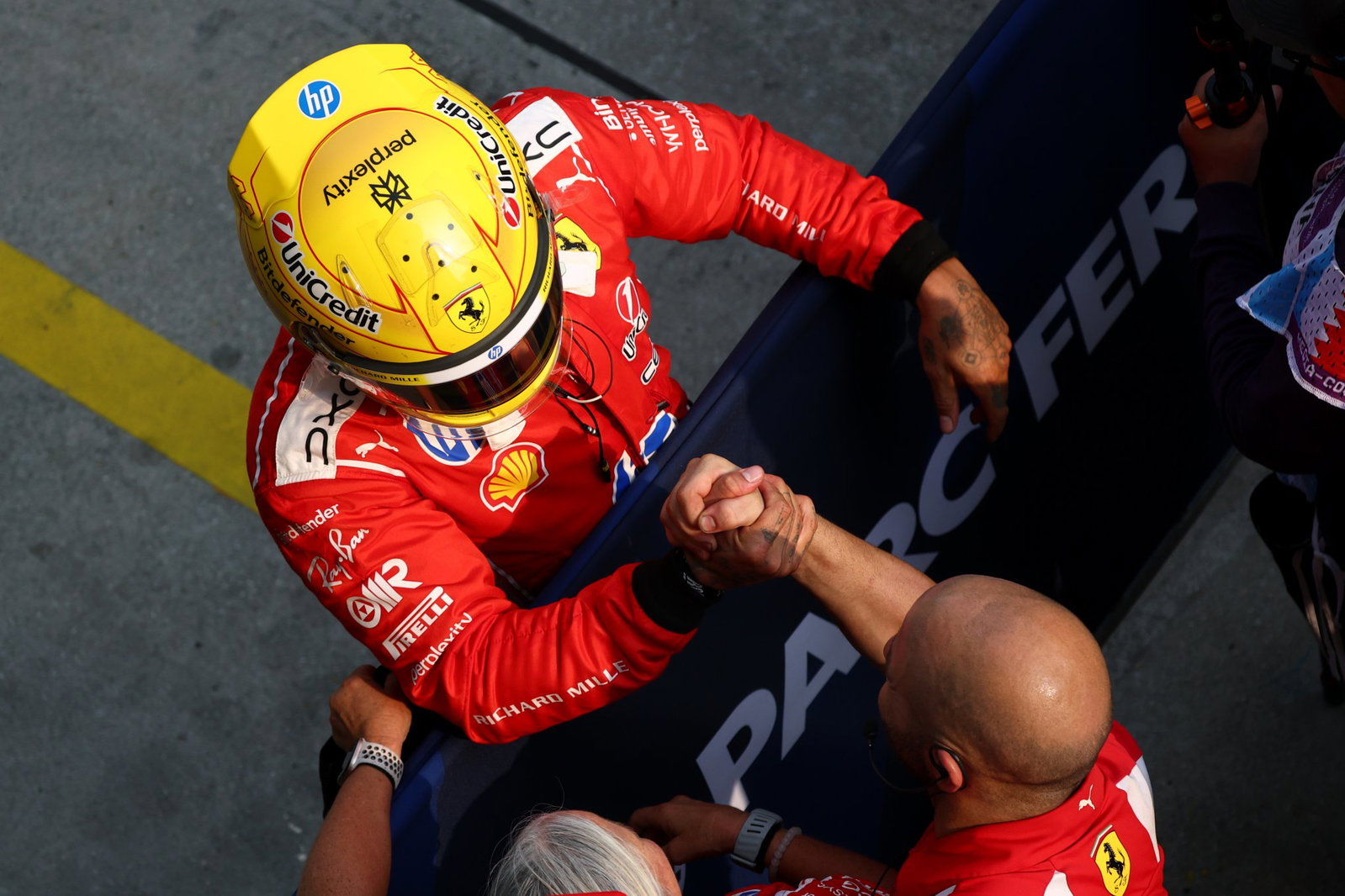 Hamilton celebrates his front-row start with his Ferrari team