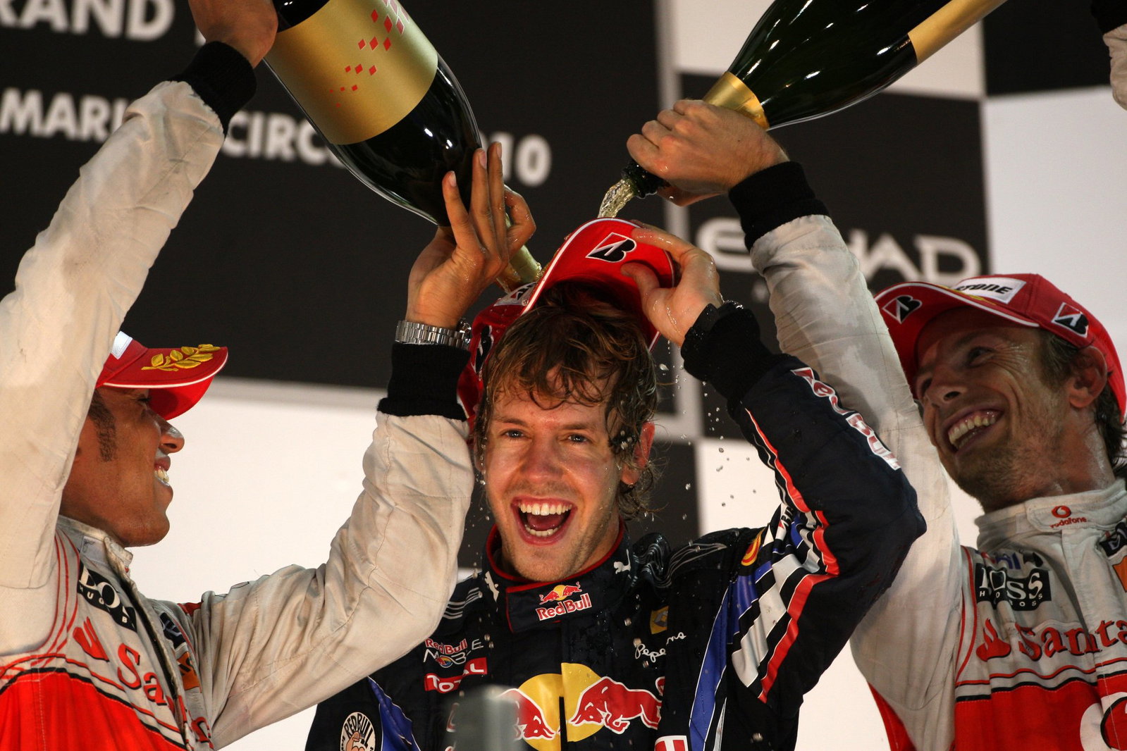 Sebastian Vettel with Lewis Hamilton and Jenson Button on the 2010 F1 Abu Dhabi Grand Prix podium. Credit: XPB.