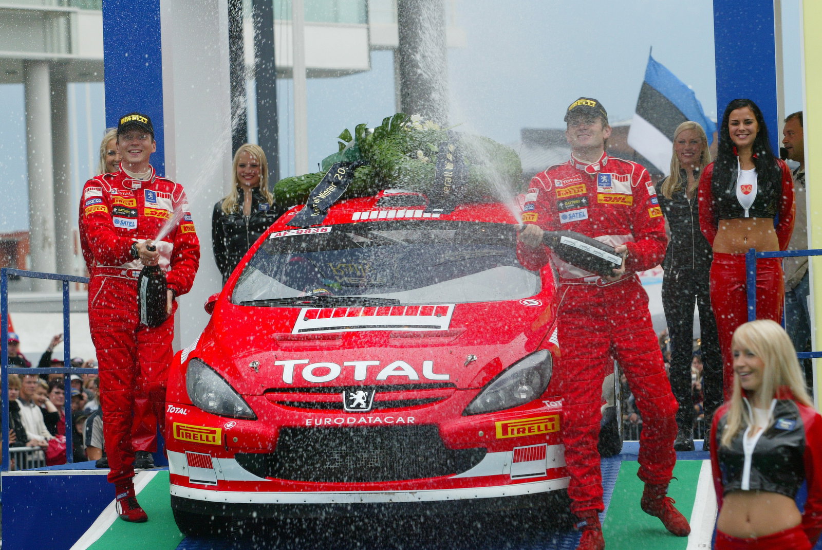 Peugeot`s Marcus Gronholm and Timo Rautiainen celebrate their Rally Finland win