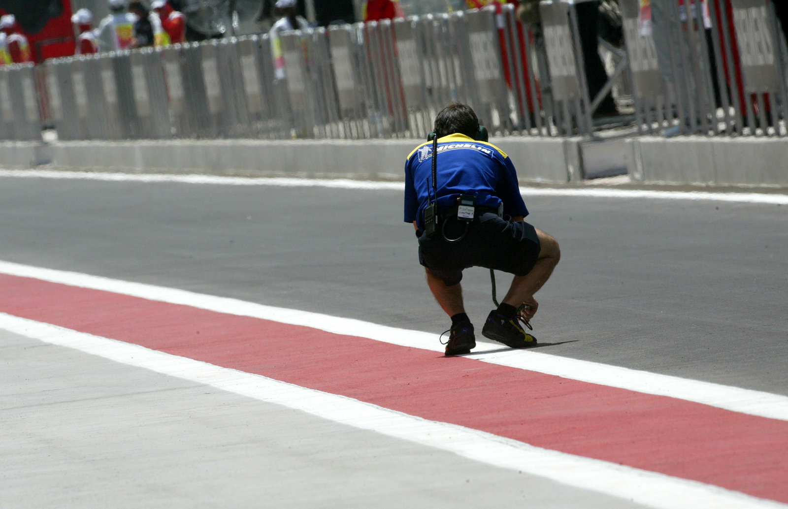 A Michelin tyre technician checks the track temperature in Bahrain