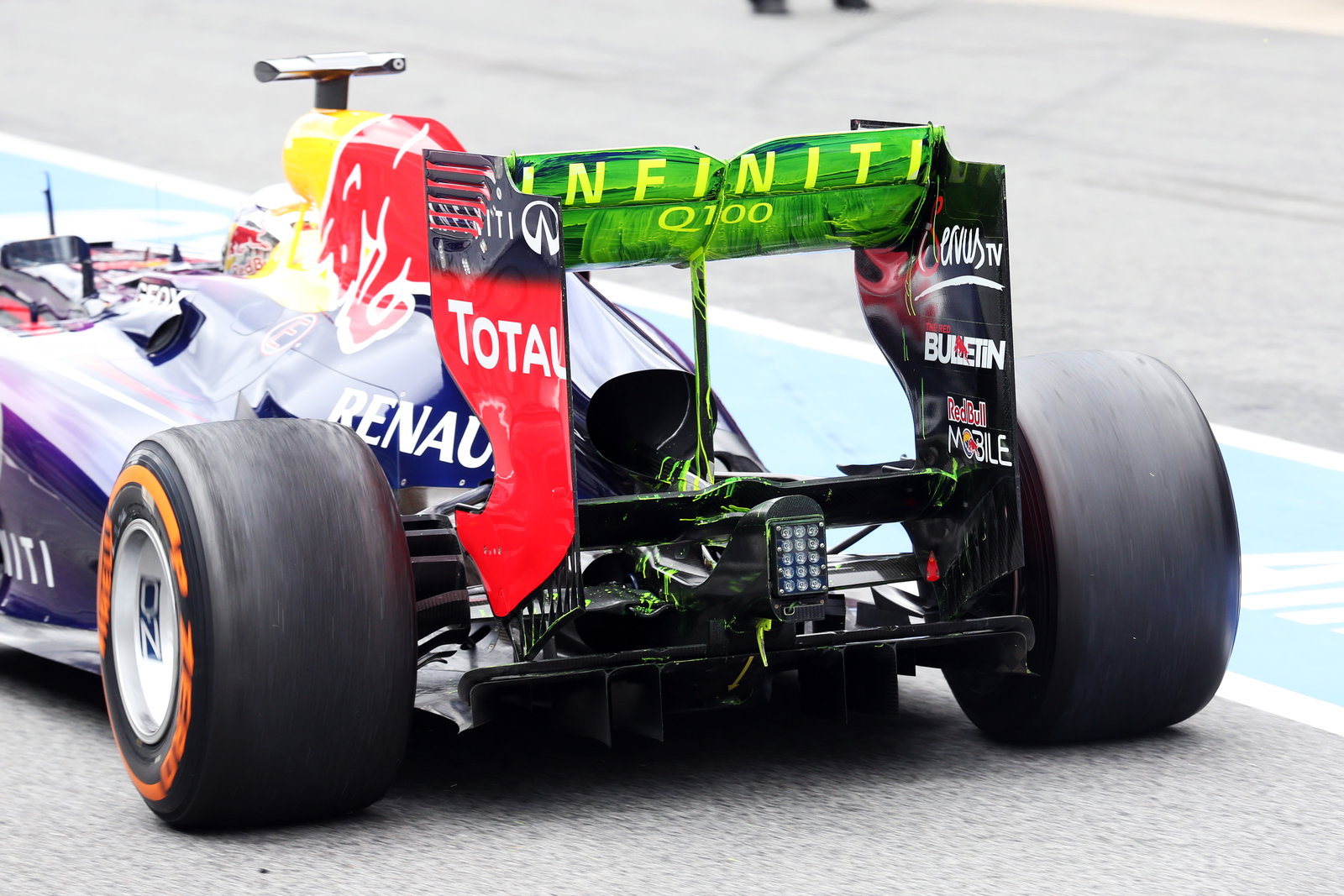 Sebastian Vettel (GER) Red Bull Racing RB9 running flow-vis paint on the rear wing and rear diffuser