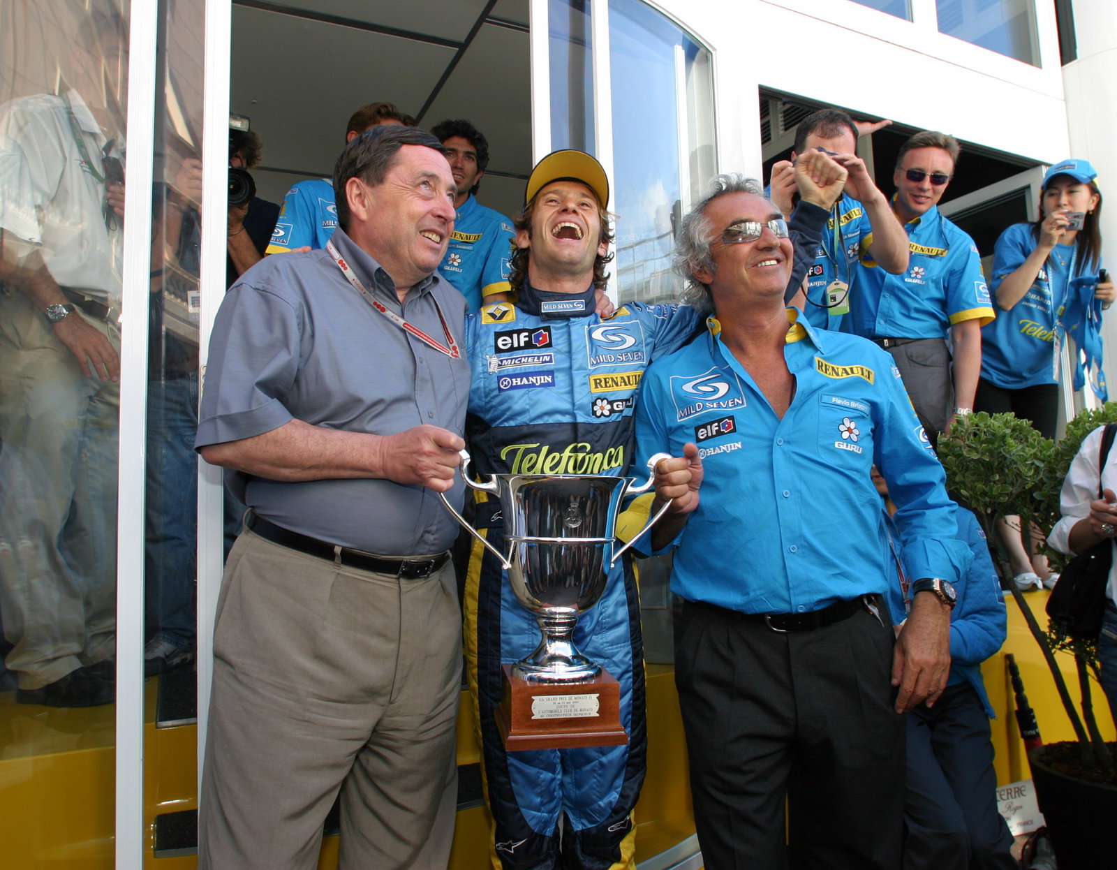 Jarno Trulli celebrates his first F1 grand prix win with Renault`s Patrick Faure and team principal
