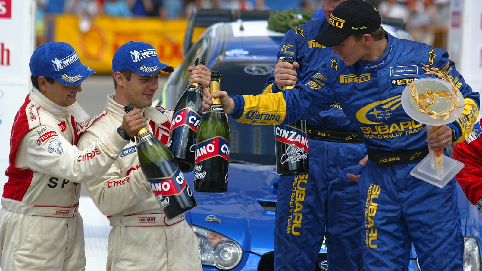 Acropolis Rally winners Petter Solberg and Phil Mills on the podium with Sebastian Loeb and Daniel E