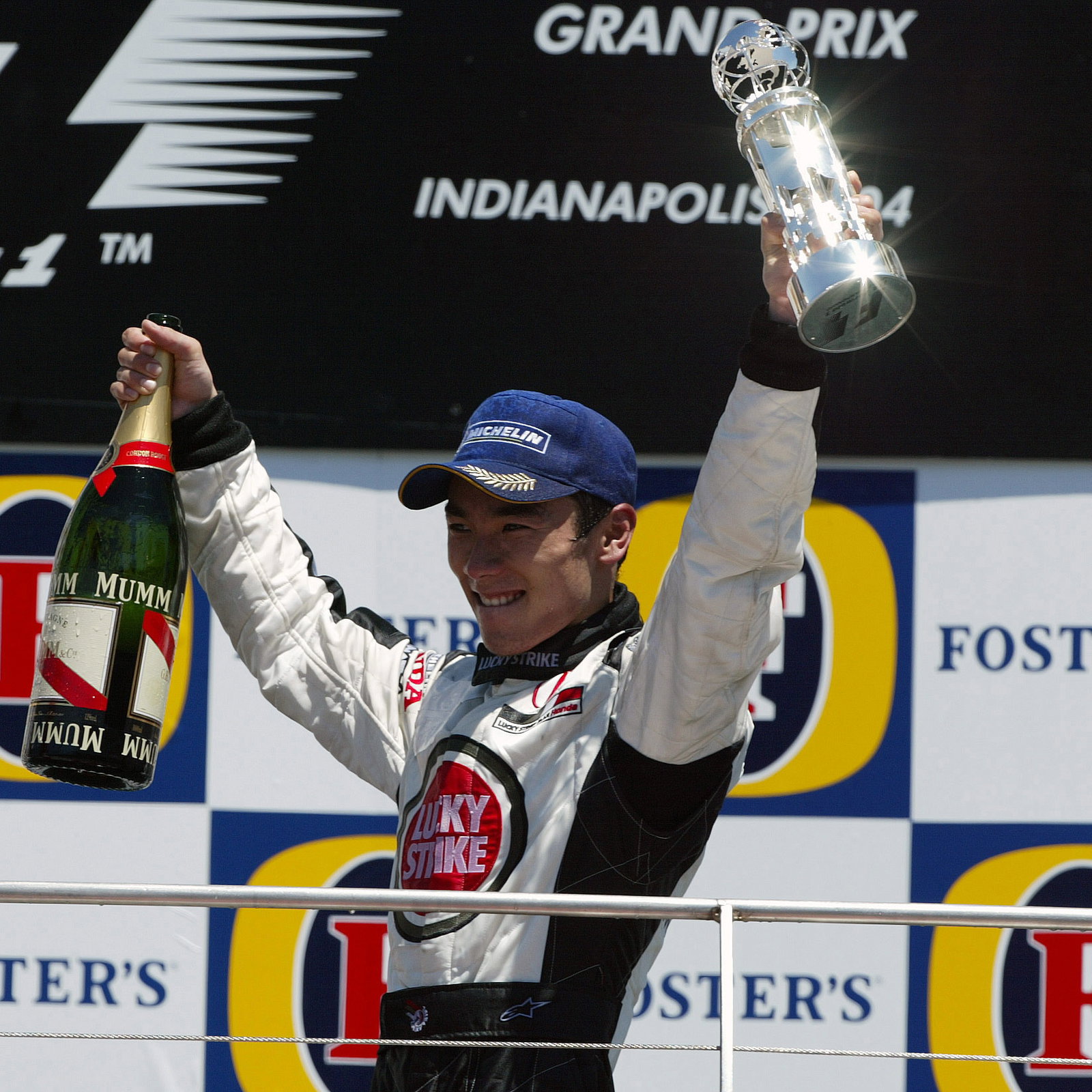 BAR-Honda`s Takuma Sato celebrates his third place finish at the US GP