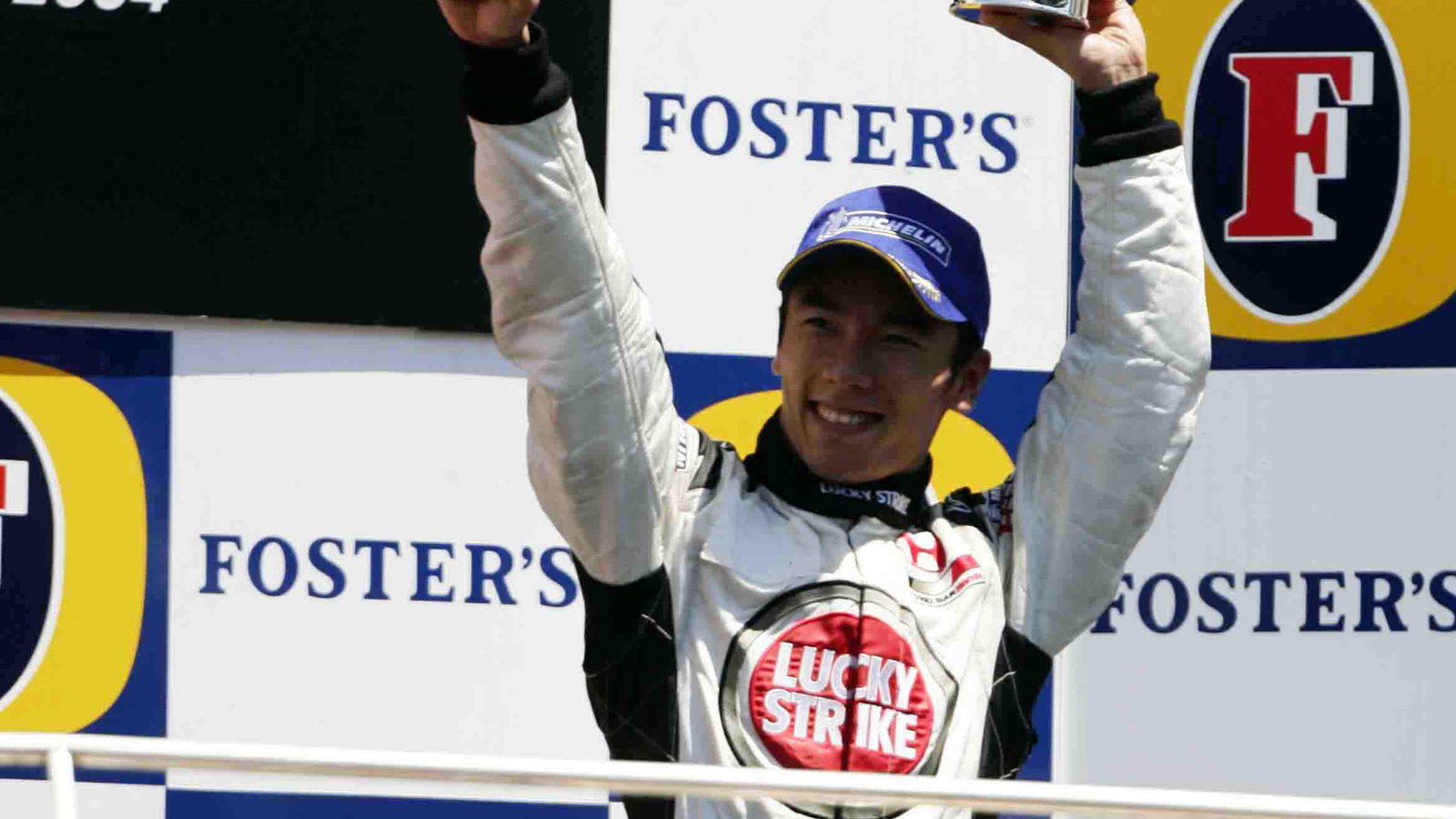 Takuma Sato celebrates his maiden podium finish in F1