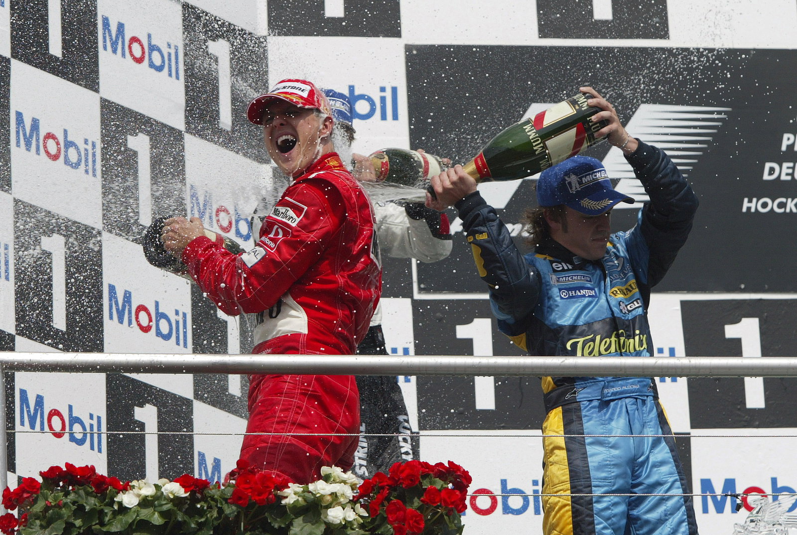 Jenson Button, Fernando Alonso and Michael Schumacher celebrate on the podium