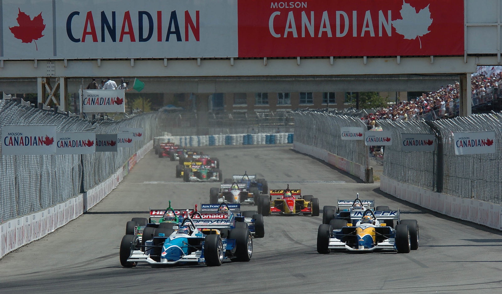 Paul Tracy gets the jump on Forsythe teammate Rodolfo Lavin at the start of the 2004 Molson Indy Van