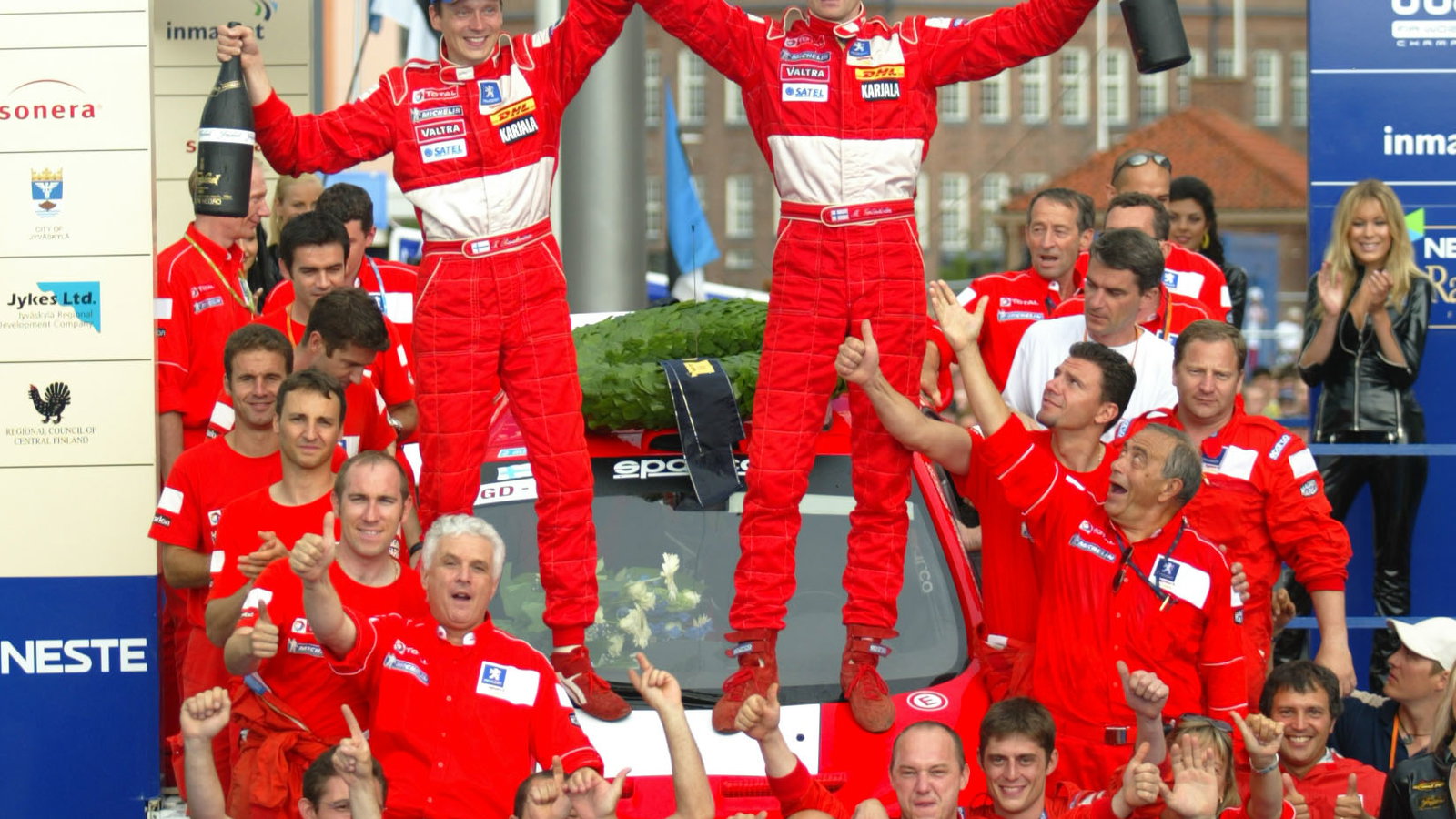 Marcus Gronholm and co-driver Timo Rautianen celebrate their Rally Finland win with the rest of the 