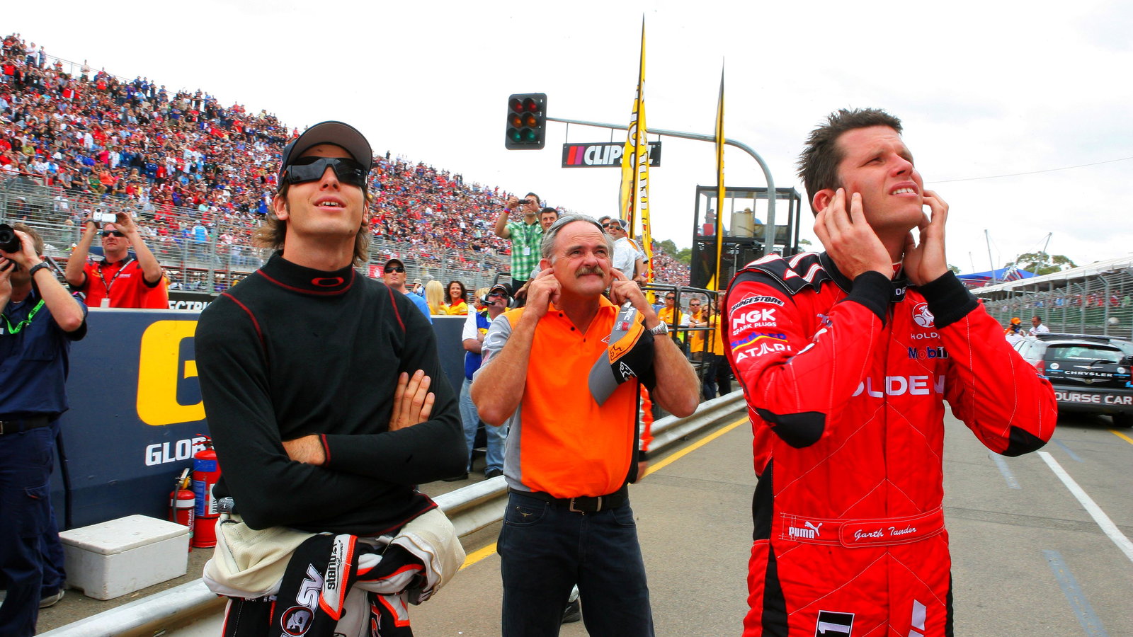 Rick Kelly (L) his dad and team owner (John Kelly (C) and Garth Tander (R) former team mate watch th