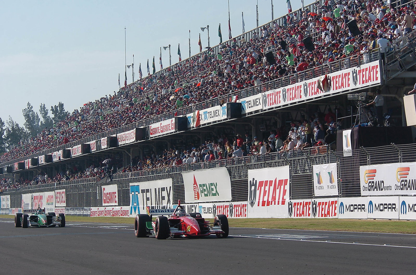 Michel Jourdain Jr and Ryan Hunter-Reay pass Mexico City`s gigantic main grandstand