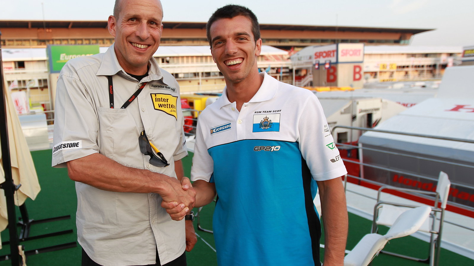 Daniel Epp and De Angelis shaking hands on Interwetten Honda MotoGP ride, Catalunya MotoGP 2010